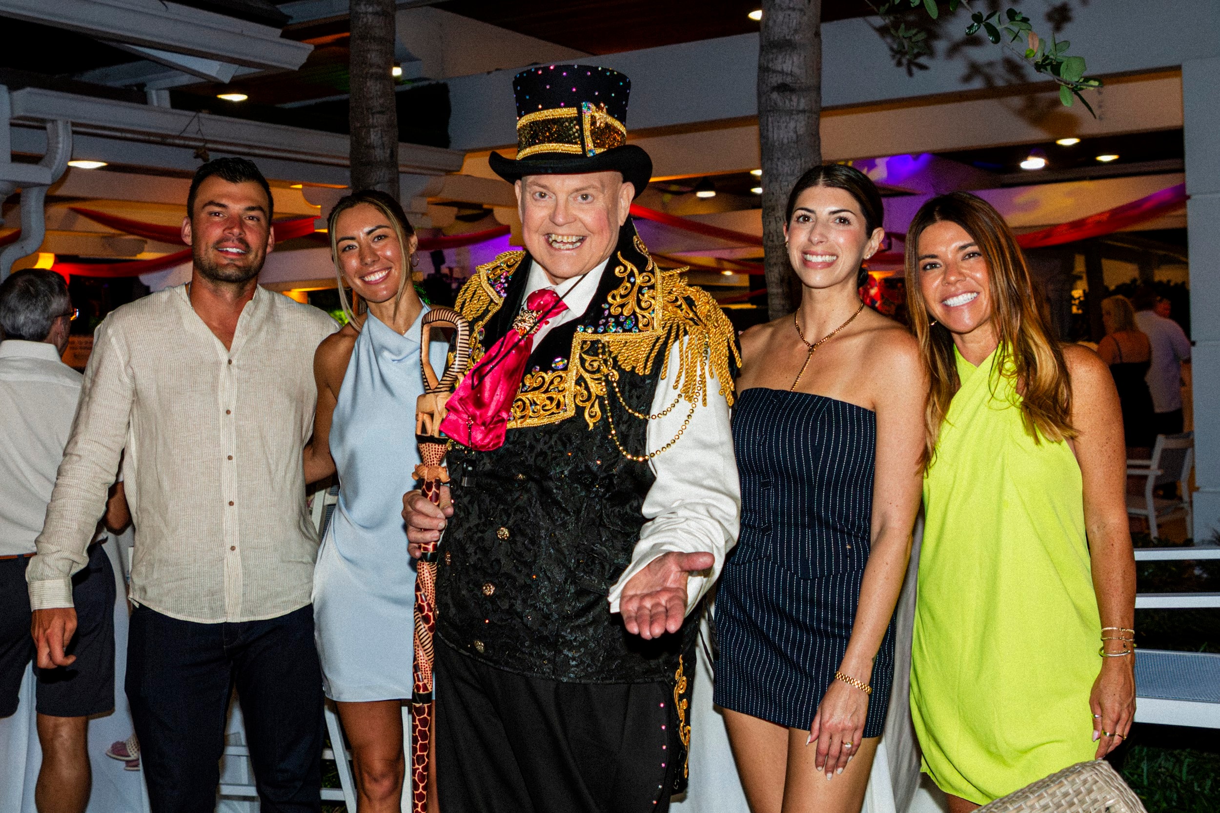 Ringmaster posing with guests at party