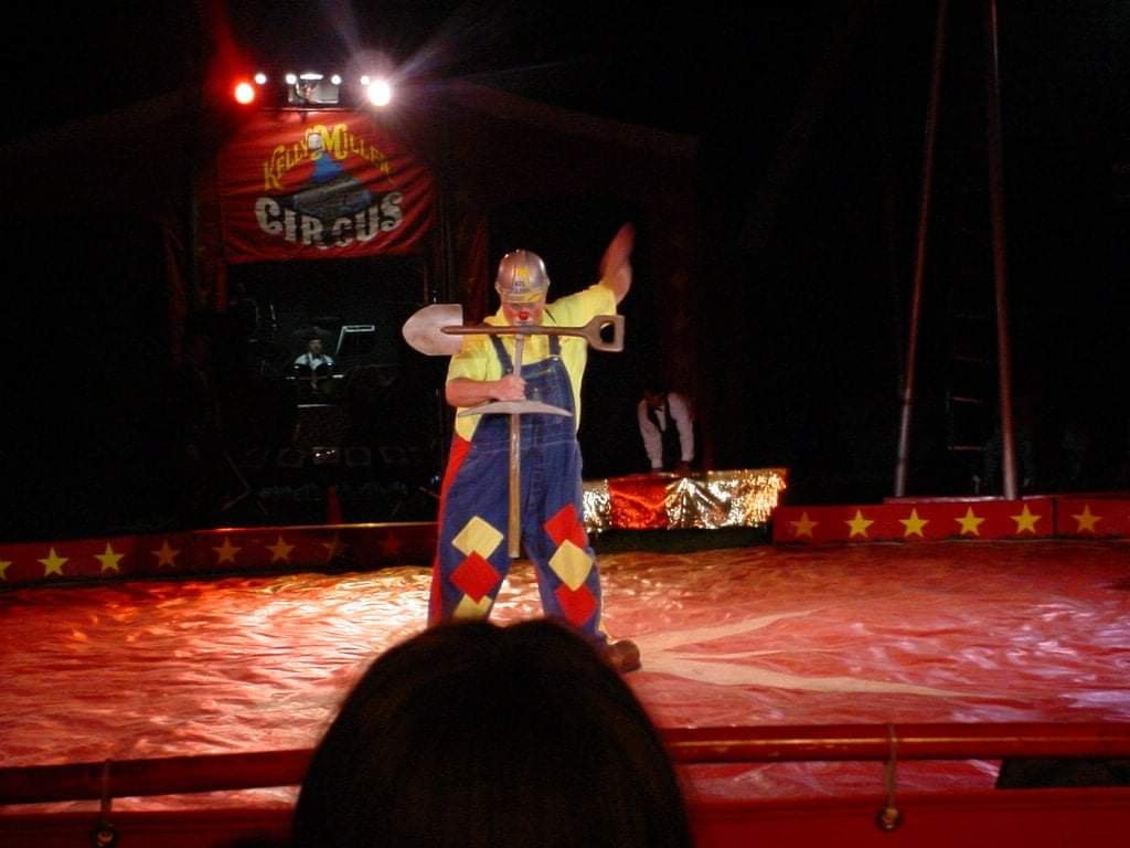 Clown performing circus act at night