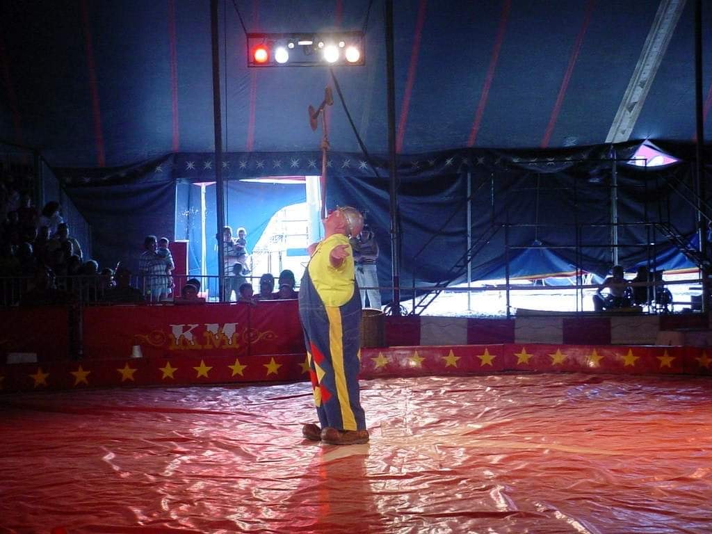 Circus performer in ring tent at night