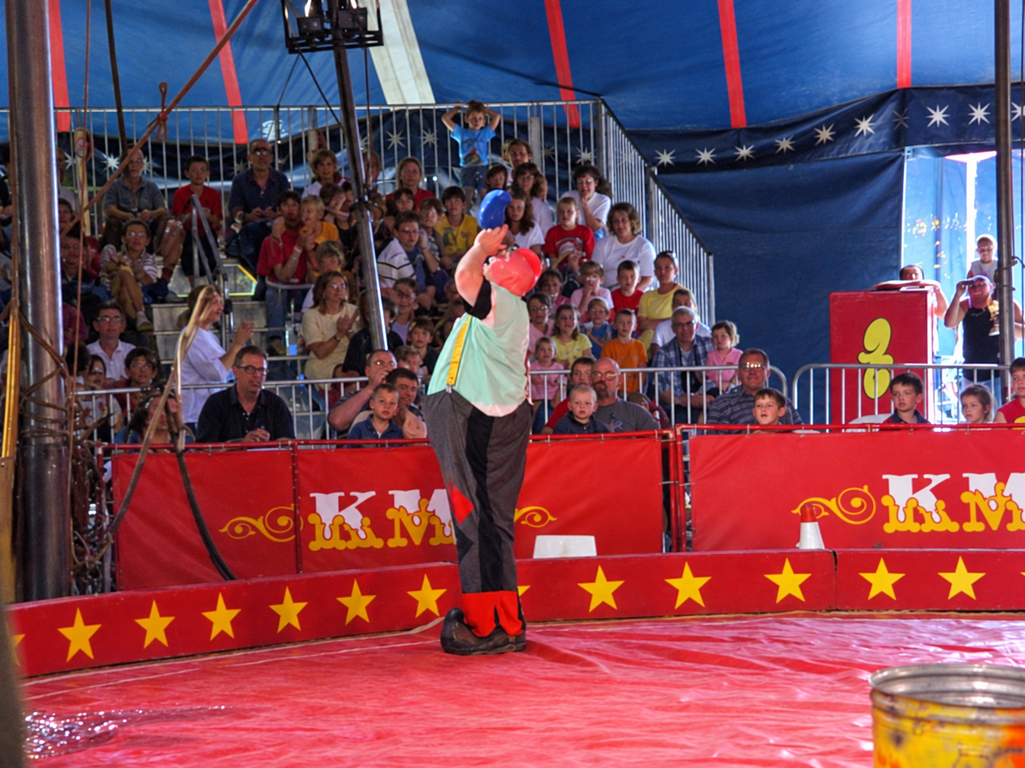 James Tiny Lambros juggling hats in circus ring