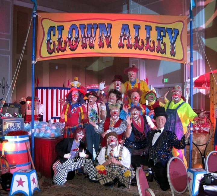 Large clown troupe under Clown Alley sign at Orlando event